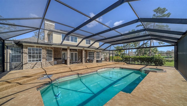 view of swimming pool featuring french doors, a patio, an in ground hot tub, and glass enclosure