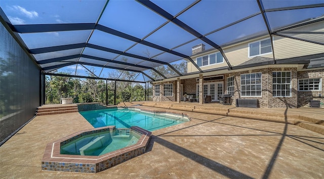 view of pool featuring a patio, french doors, a lanai, and an in ground hot tub