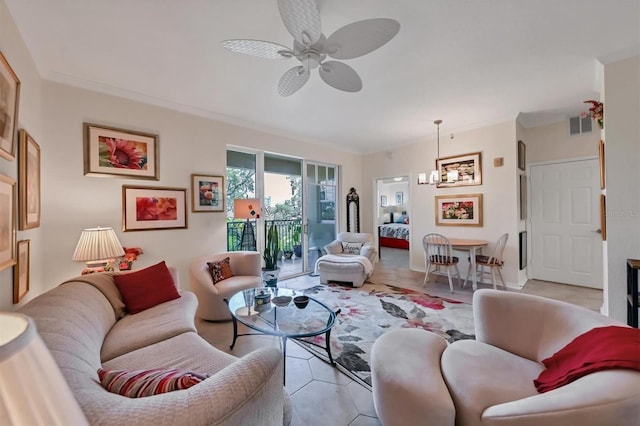 living room featuring light tile patterned floors, ceiling fan with notable chandelier, and ornamental molding