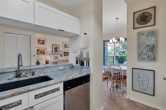 kitchen featuring white cabinetry, sink, light stone counters, stainless steel dishwasher, and a chandelier