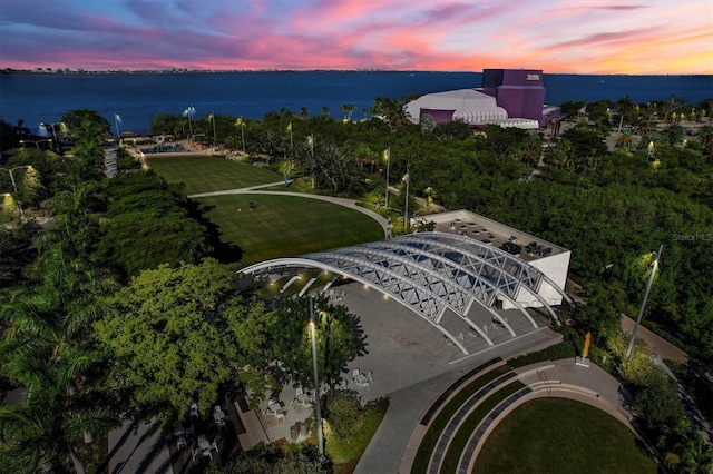 aerial view at dusk featuring a water view