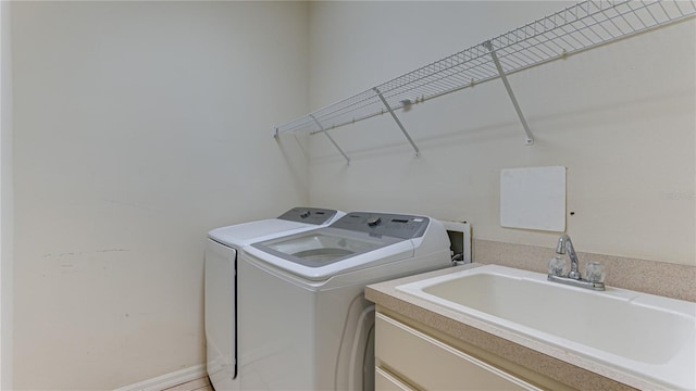 washroom featuring washer and dryer and sink