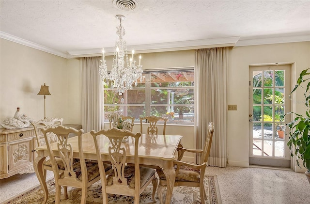 dining room with an inviting chandelier, ornamental molding, and a textured ceiling