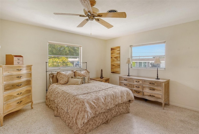 bedroom featuring multiple windows and ceiling fan