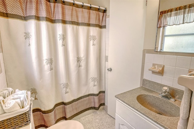 bathroom featuring vanity, a shower with curtain, toilet, and tile walls