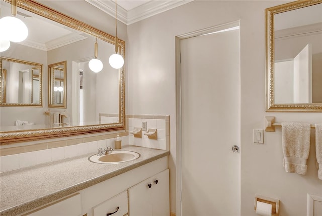 bathroom with tasteful backsplash, crown molding, and vanity