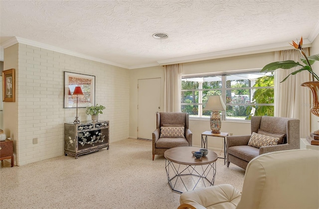 sitting room with ornamental molding, brick wall, and a textured ceiling