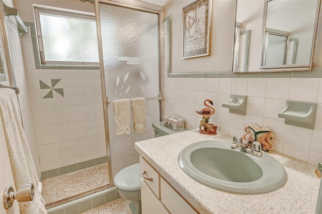 bathroom with vanity, tile walls, an enclosed shower, and toilet