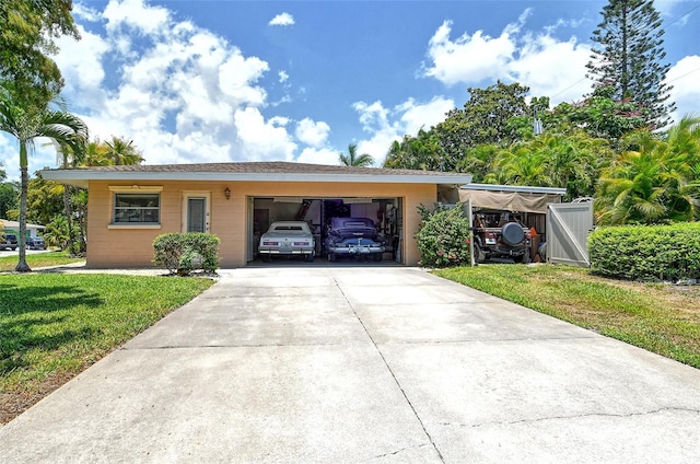 ranch-style house featuring a garage and a front lawn