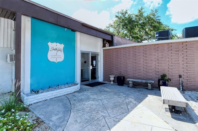 entrance to property with a patio area and central air condition unit