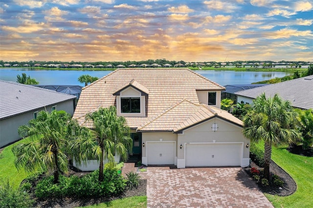 view of front of property featuring a garage and a water view