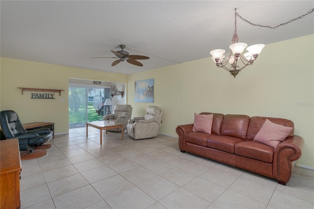 tiled living room featuring a textured ceiling and ceiling fan with notable chandelier