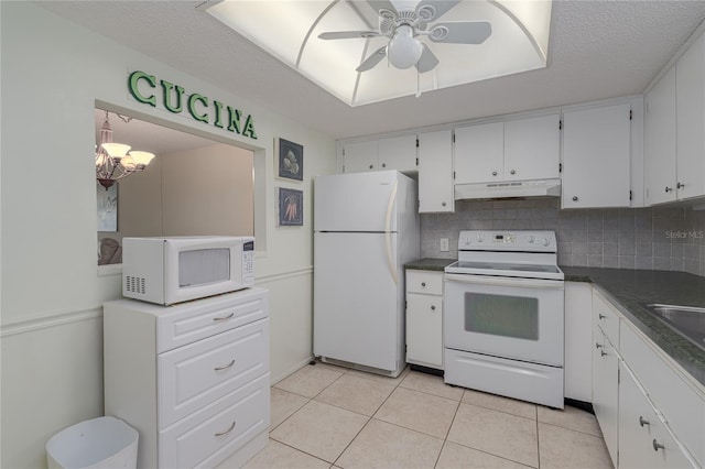 kitchen with white appliances, white cabinets, decorative backsplash, light tile patterned flooring, and ceiling fan