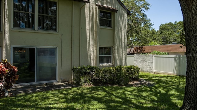 view of side of home featuring a yard