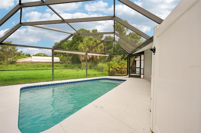 view of swimming pool featuring a patio area and a lanai