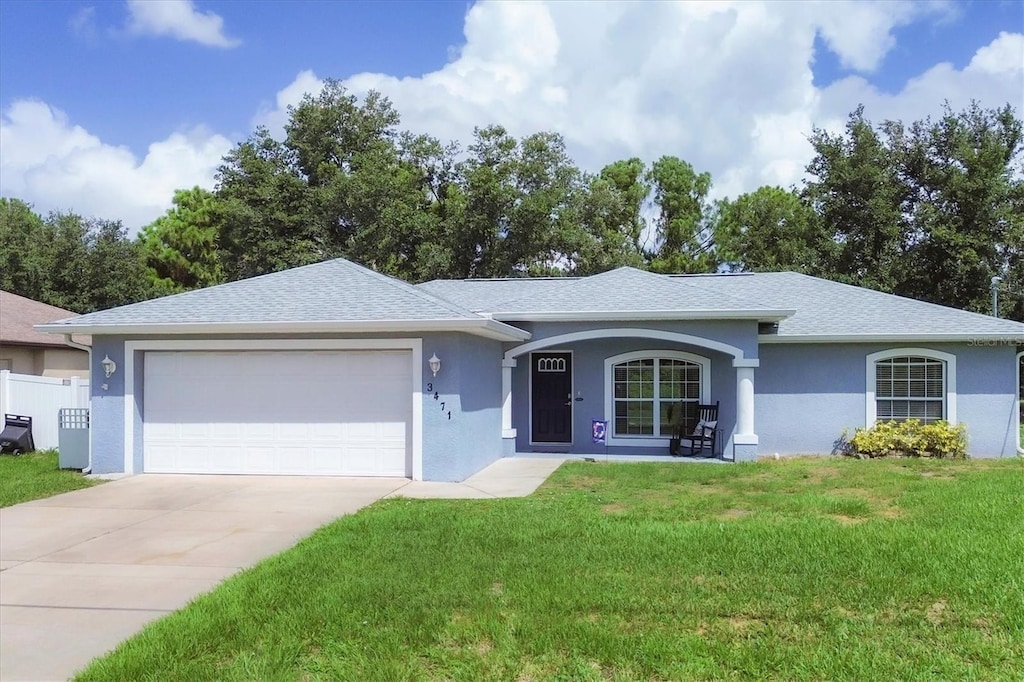 ranch-style house with a front lawn and a garage