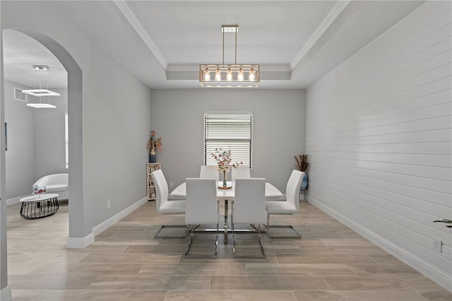 dining room featuring a raised ceiling