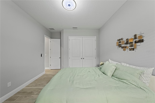 bedroom with a closet and hardwood / wood-style floors