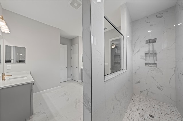 bathroom featuring a tile shower, tile flooring, and vanity