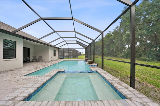 view of pool featuring a patio, glass enclosure, and a lawn