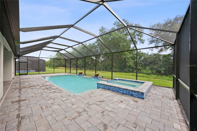 view of swimming pool featuring an in ground hot tub, a lanai, and a patio area