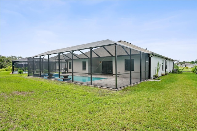 rear view of house with a patio, a lanai, and a yard