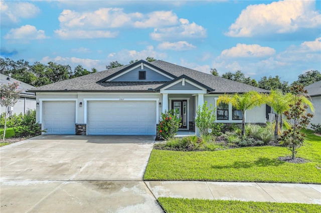 view of front of home with a front yard and a garage