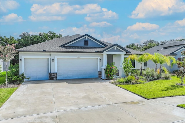 view of front of home featuring a garage, a front yard, and central air condition unit