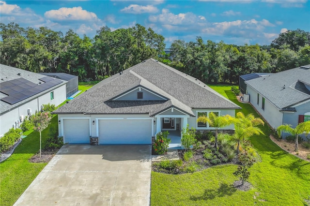 view of front facade featuring a garage, a front lawn, and solar panels