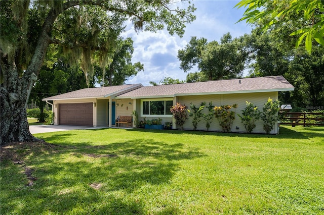 ranch-style home with a front yard and a garage