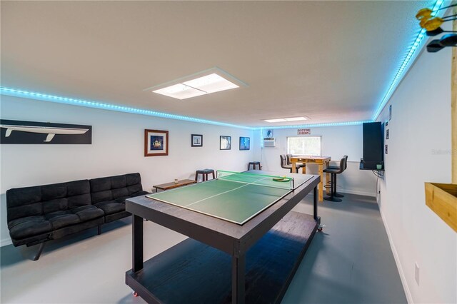 game room featuring concrete floors and indoor bar