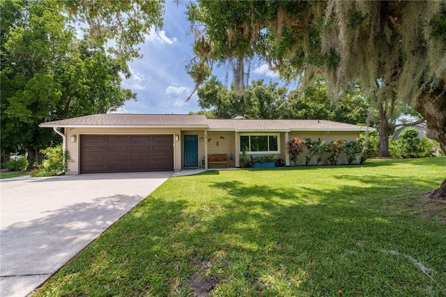 ranch-style house featuring a front yard and a garage