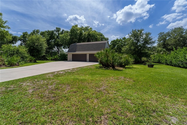 ranch-style home with a garage, an outbuilding, and a front yard