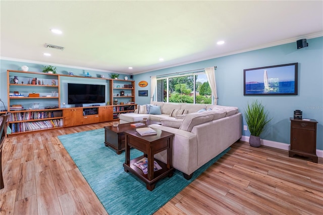 living room with wood-type flooring and ornamental molding