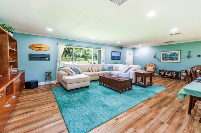 living room featuring hardwood / wood-style floors and crown molding