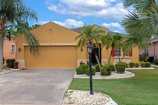 view of front of home featuring a garage, central AC, and a front lawn