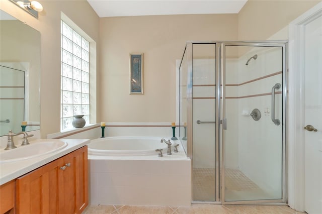 bathroom featuring a wealth of natural light, vanity with extensive cabinet space, and separate shower and tub