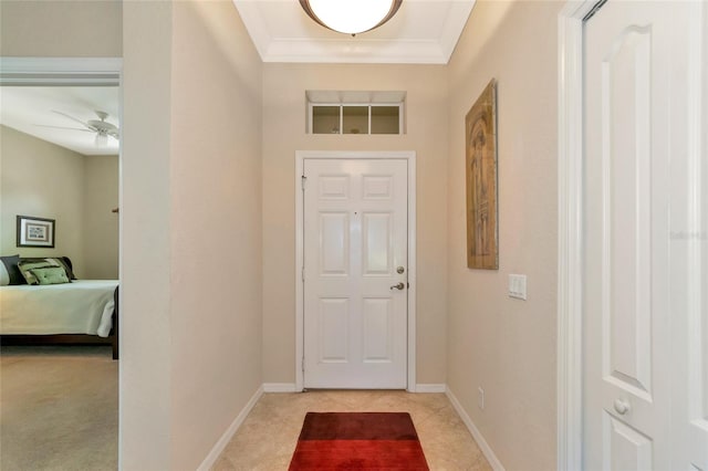 tiled foyer entrance featuring ornamental molding and ceiling fan