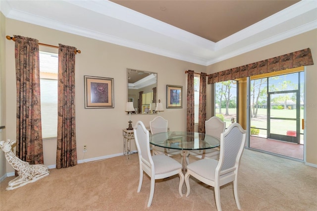 carpeted dining area with crown molding