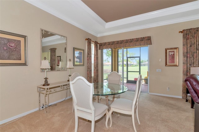 dining room with light carpet and crown molding