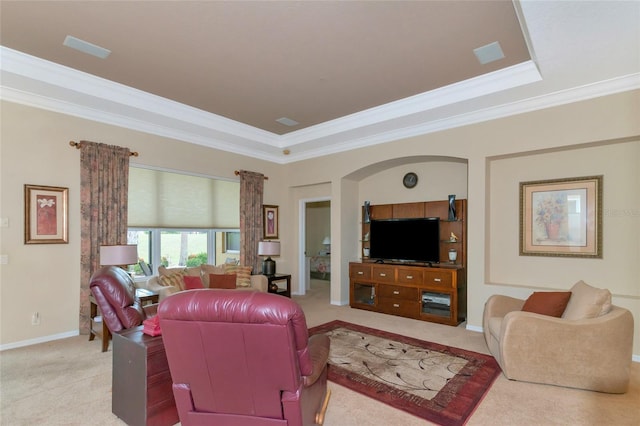 living room featuring a tray ceiling, crown molding, and carpet flooring