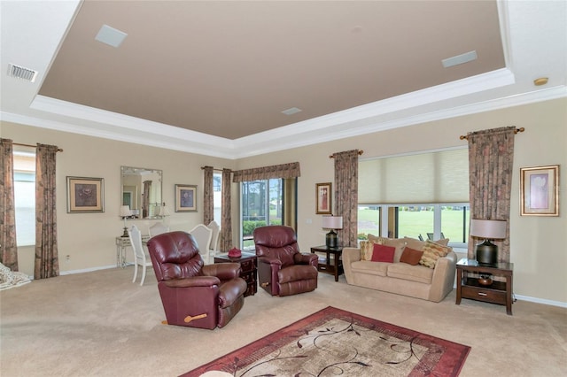 living room with carpet flooring, plenty of natural light, and a tray ceiling