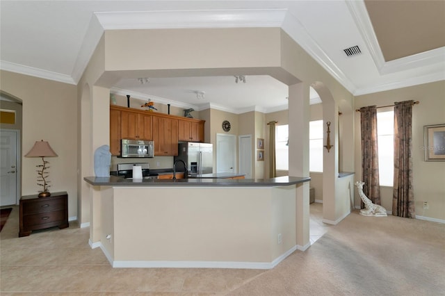 kitchen with ornamental molding, light tile floors, and appliances with stainless steel finishes