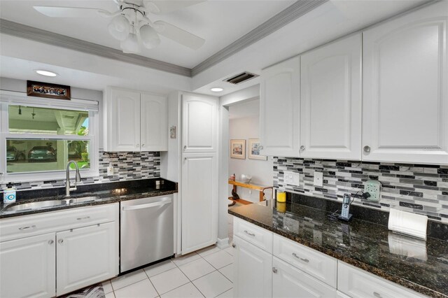 kitchen featuring white cabinetry, dishwasher, dark stone counters, and sink