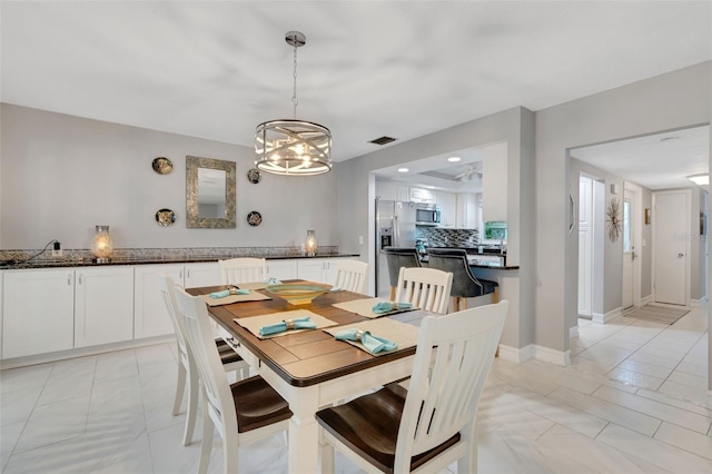 dining area with a notable chandelier