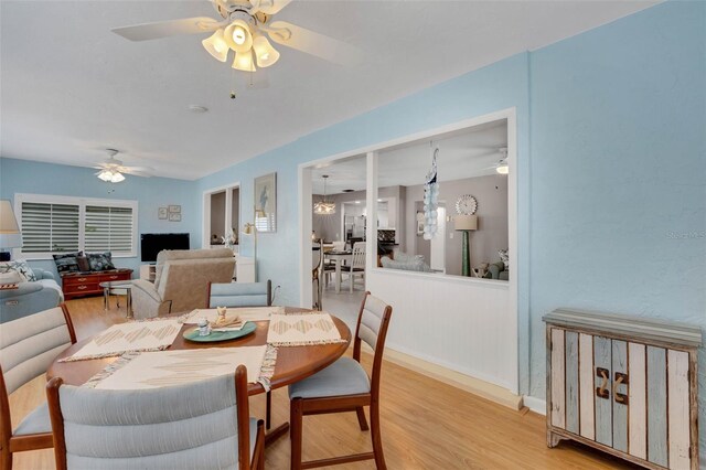 dining area featuring ceiling fan and wood-type flooring