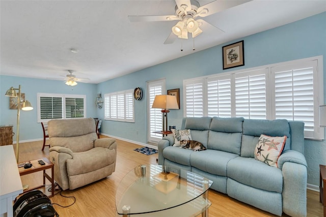 living room featuring light wood-type flooring and ceiling fan