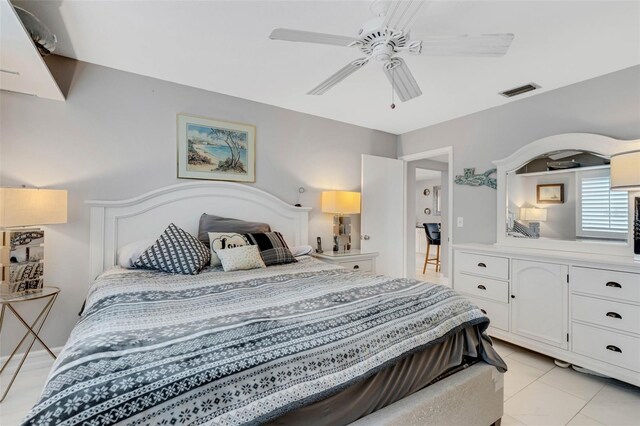 tiled bedroom featuring ceiling fan