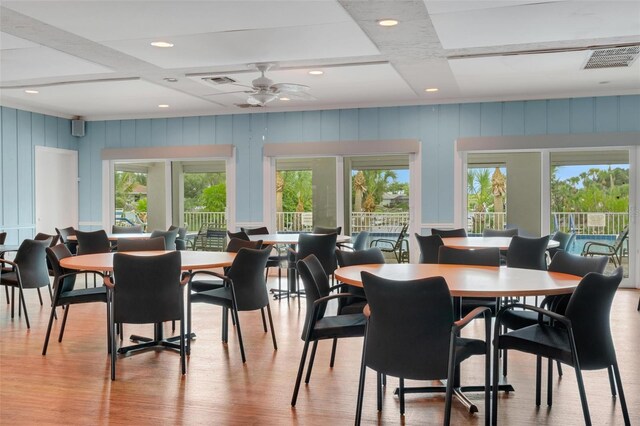 dining room with coffered ceiling, ceiling fan, and light hardwood / wood-style flooring