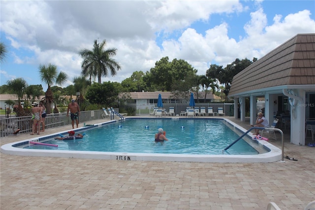 view of swimming pool with a patio area